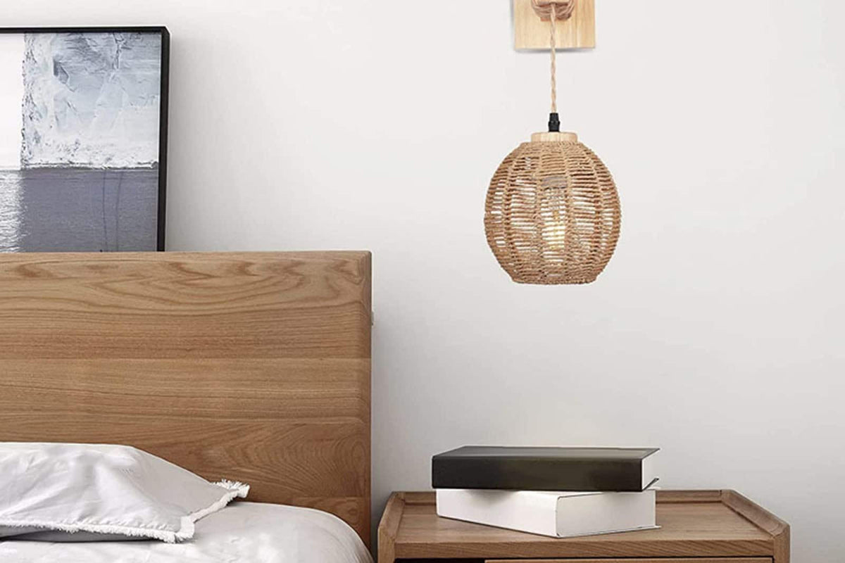 Hanging handwoven rattan ball wall light – shown in a room setting