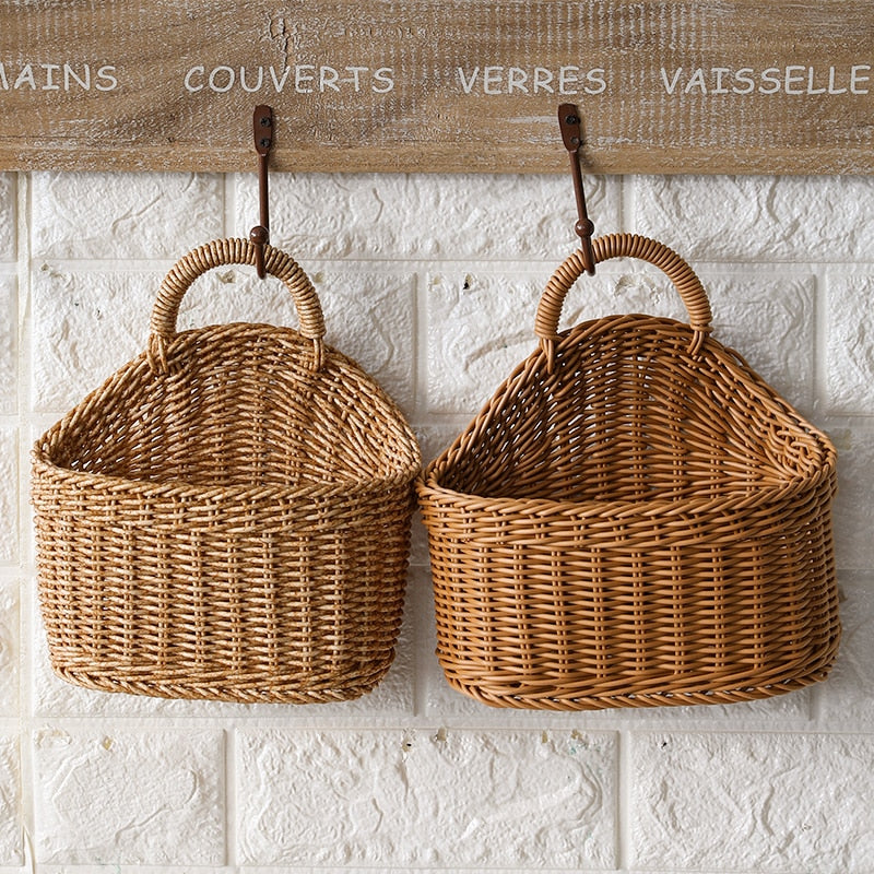 Woven natural rattan storage basket with a sturdy handle – shown in a room setting (2)