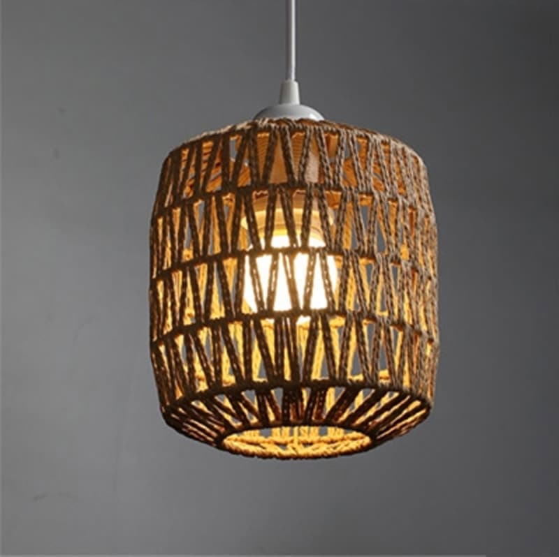 Rustic woven rattan lamp shade with golden reflections – rectangular variant, shown lit