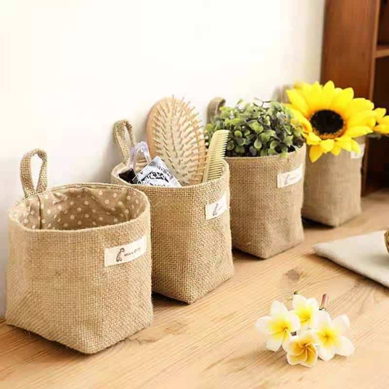Woven hanging wall storage basket shaped like a bag – shown in a room setting