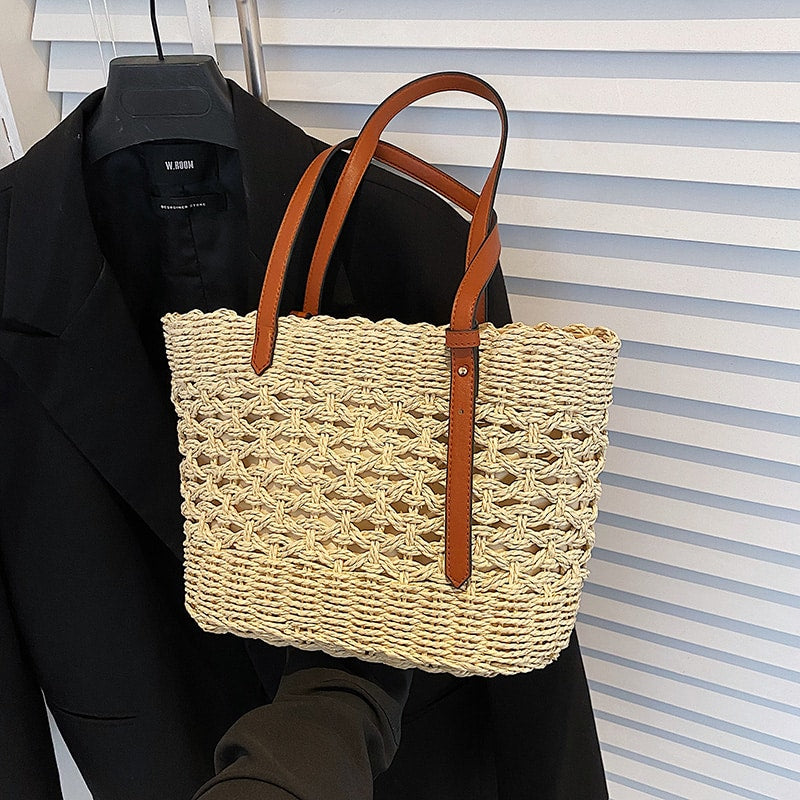 Structured handwoven straw handbag – beige variant, worn by a model