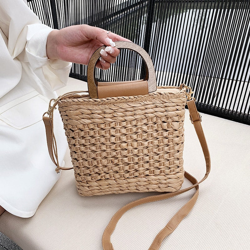 Retro woven crossbody bag with a varnished wooden handle – worn by a model