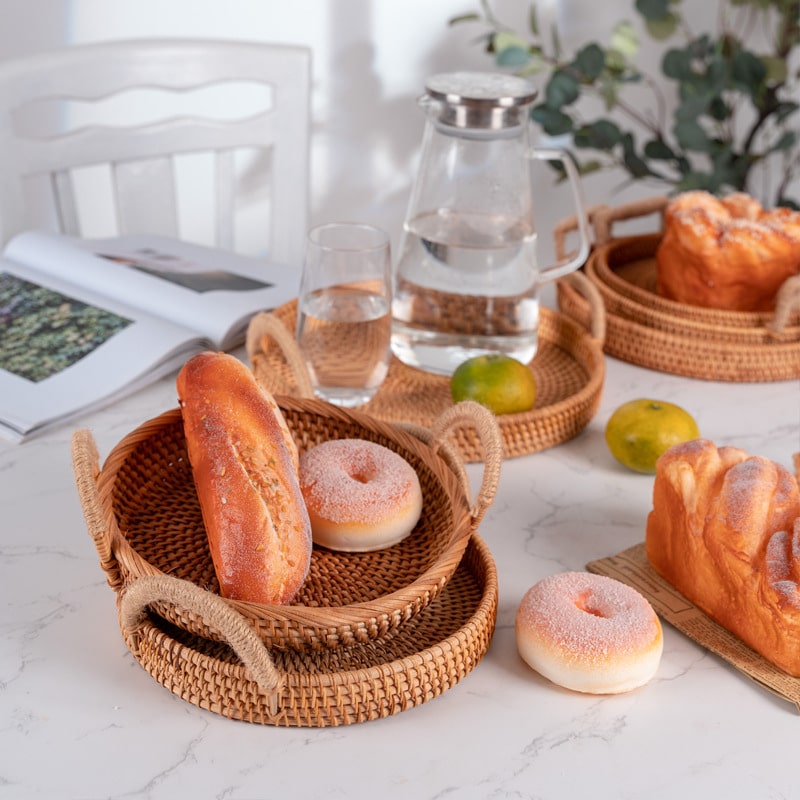Large handwoven rattan tray with side handles – shown in a room setting