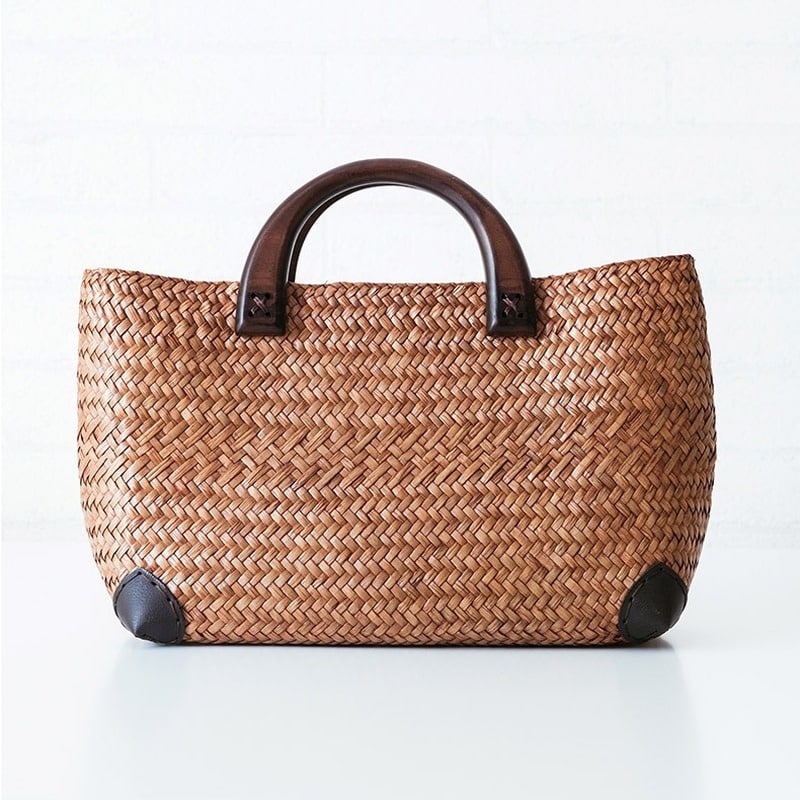 Elegant rattan tote with polished wooden handles