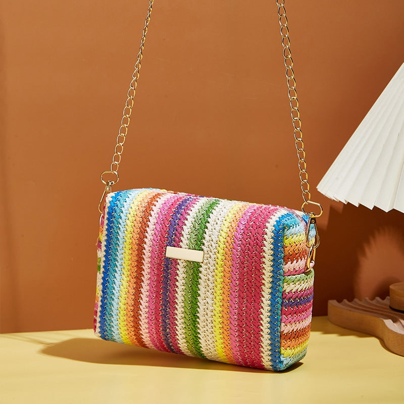 Small multicolor rattan handbag with bold color bands – shown in a room setting