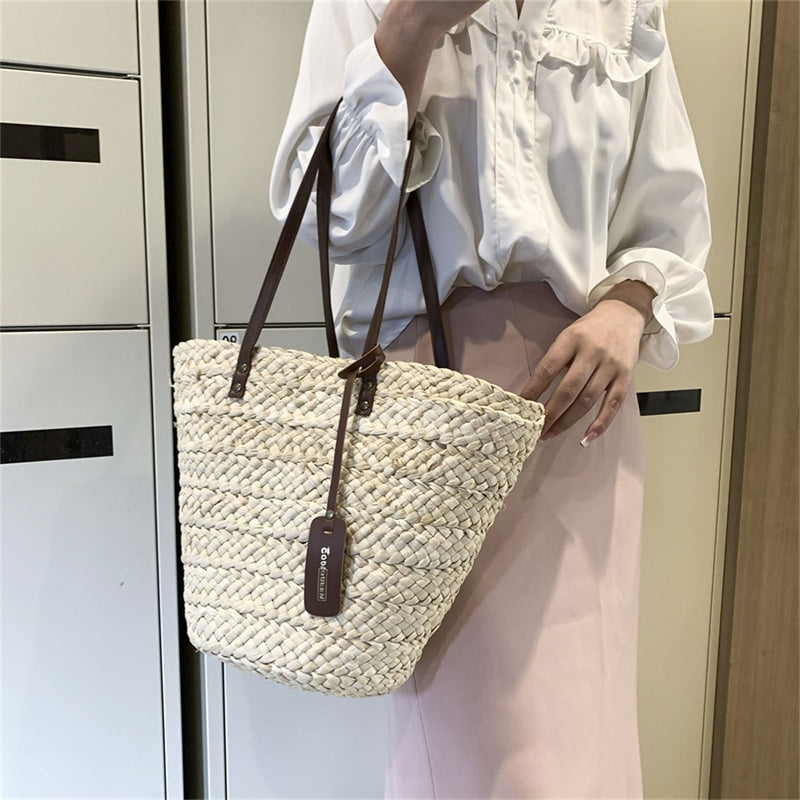 Boho handwoven straw handbag – worn by a model