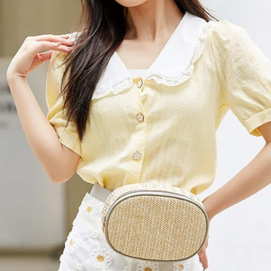 Round woven straw belt bag – worn by a model