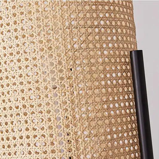 Modern cylindrical rattan table lamp on a matte metal stand – close-up detail