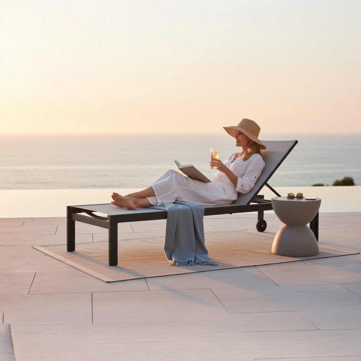 Nicky black aluminum chaise lounge with gray textilene – shown outdoors