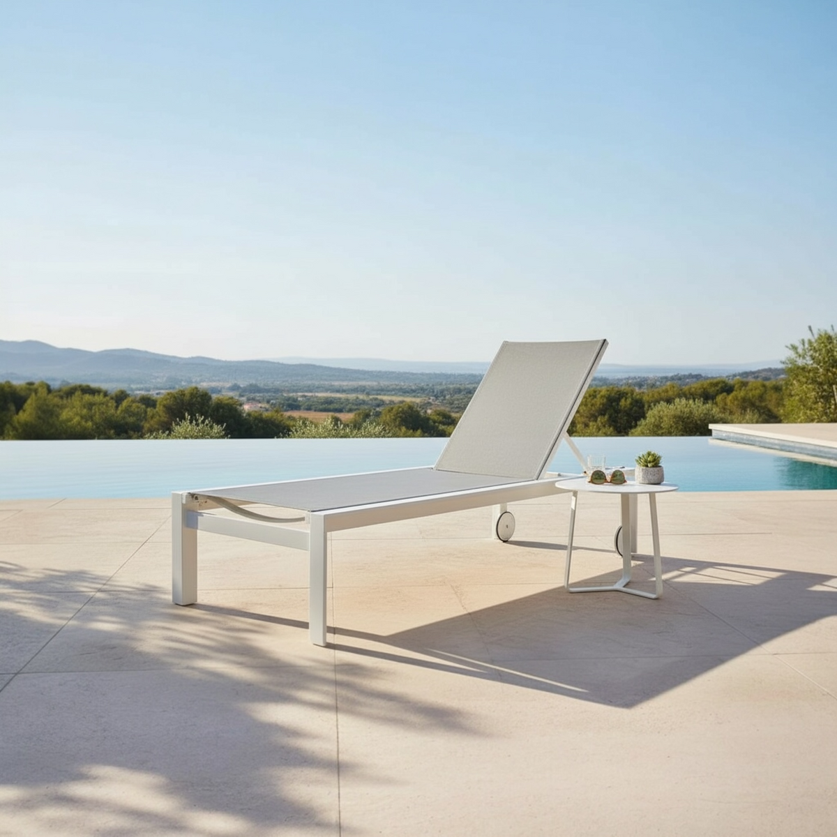 Nicky white aluminum chaise lounge with gray textilene – shown outdoors