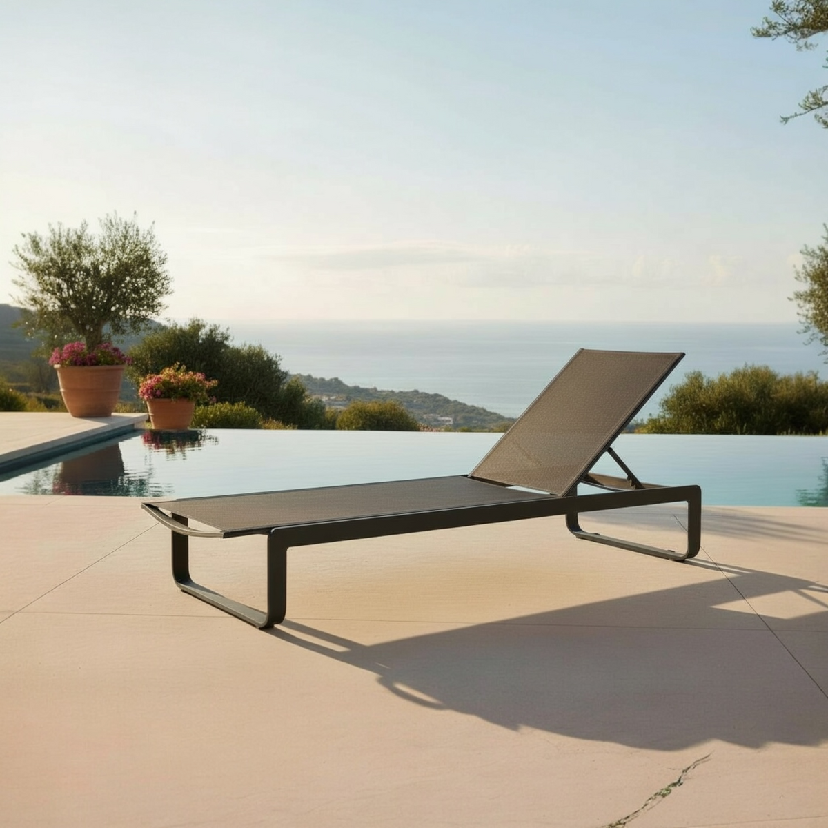 Romy black aluminum chaise lounge with black textilene – shown outdoors