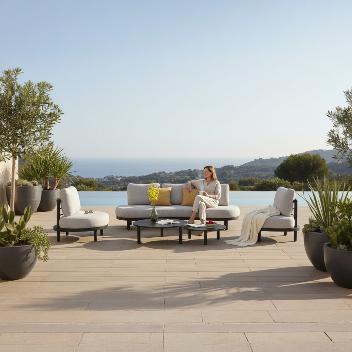 Ambre black aluminum sofa set with beige cushions – shown outdoors (2)