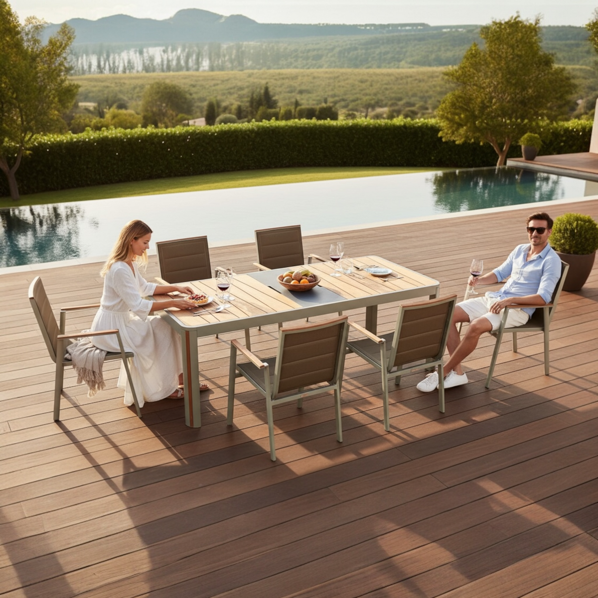 Armchair from the Geneva aluminum and teak outdoor dining set with center ice bucket – shown outdoors