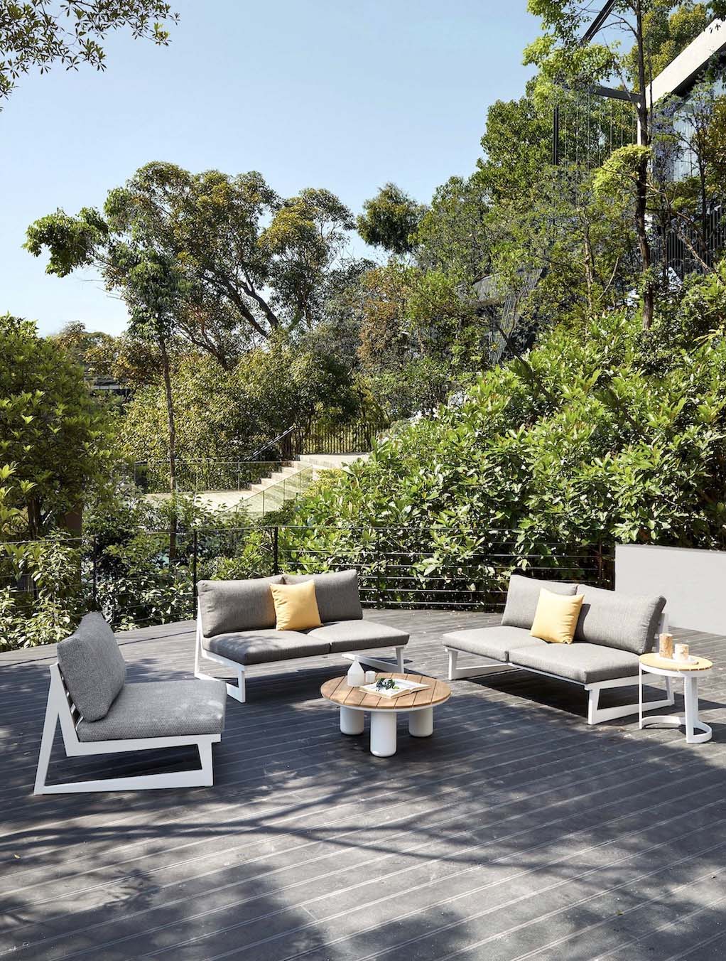 Leo white aluminum patio set with gray olefin cushions and round teak coffee table – shown outdoors (4)