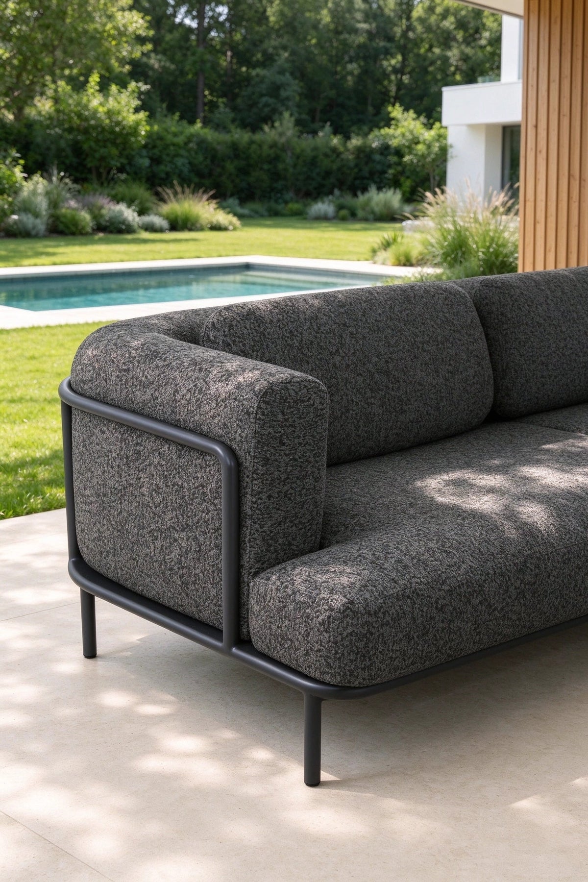 Flora anthracite aluminum loveseat set upholstered in black boucle – shown outdoors (2)