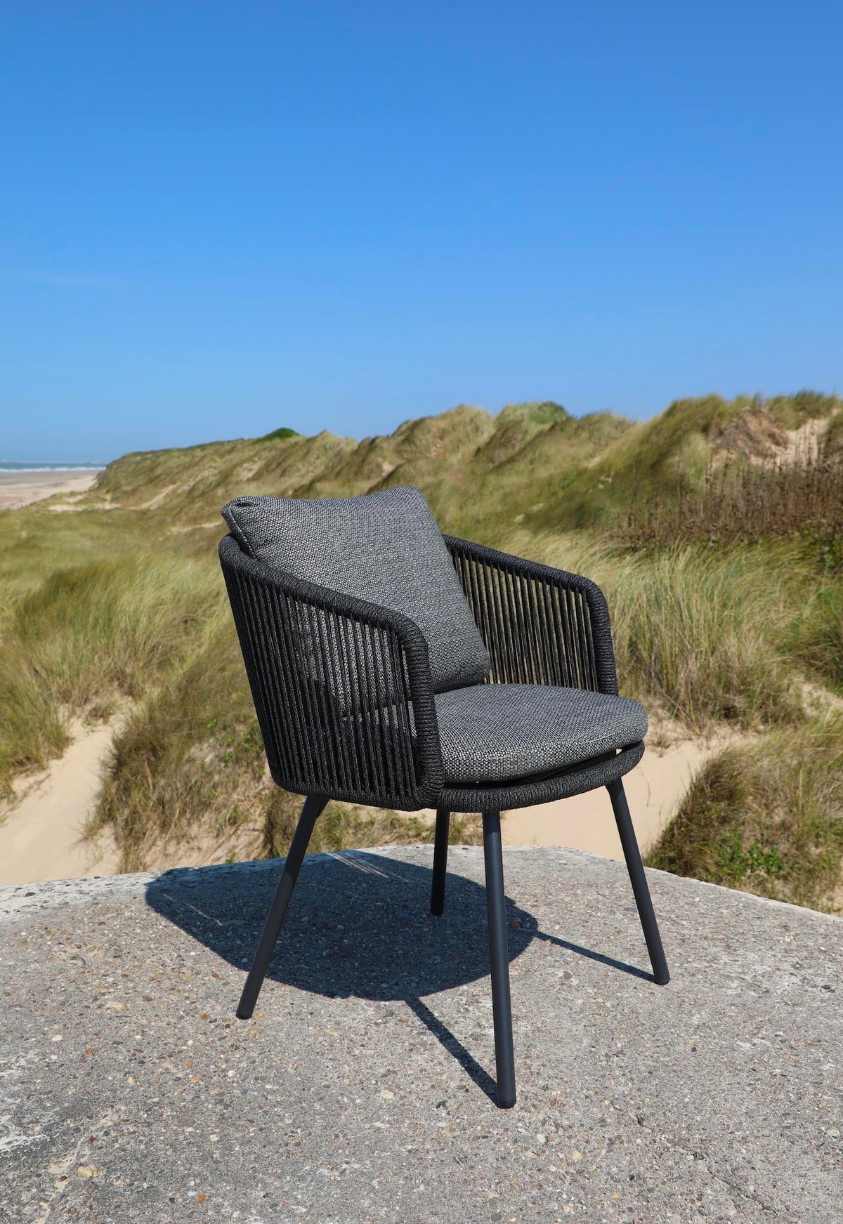 Livio black aluminum and rope outdoor dining armchair – shown outdoors (7)