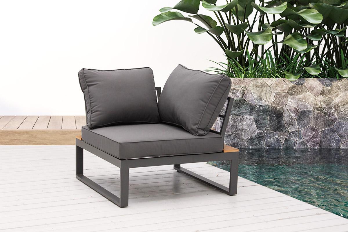 Corner chair from the Stacy anthracite aluminum corner patio set with wood-look table – shown outdoors