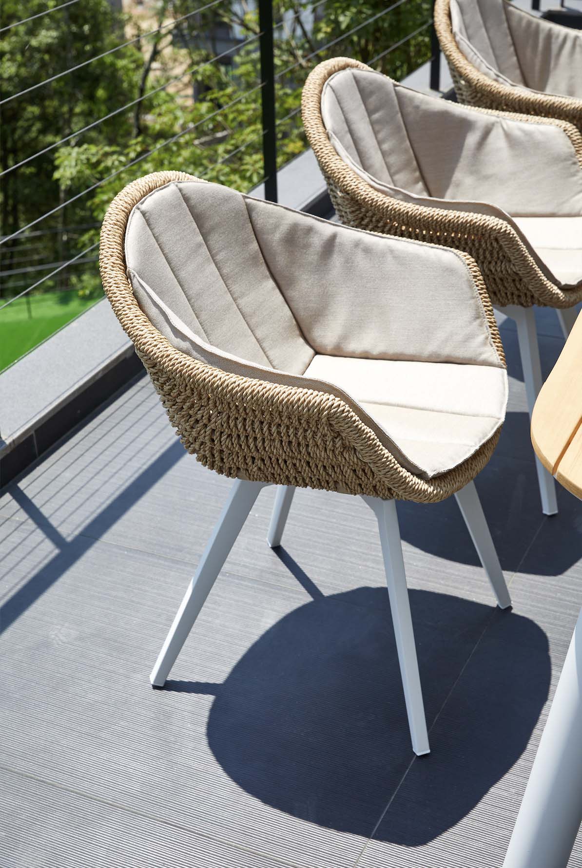 Milo resin wicker dining armchairs with ecru Agora cushions, set of 2 – shown outdoors (3)