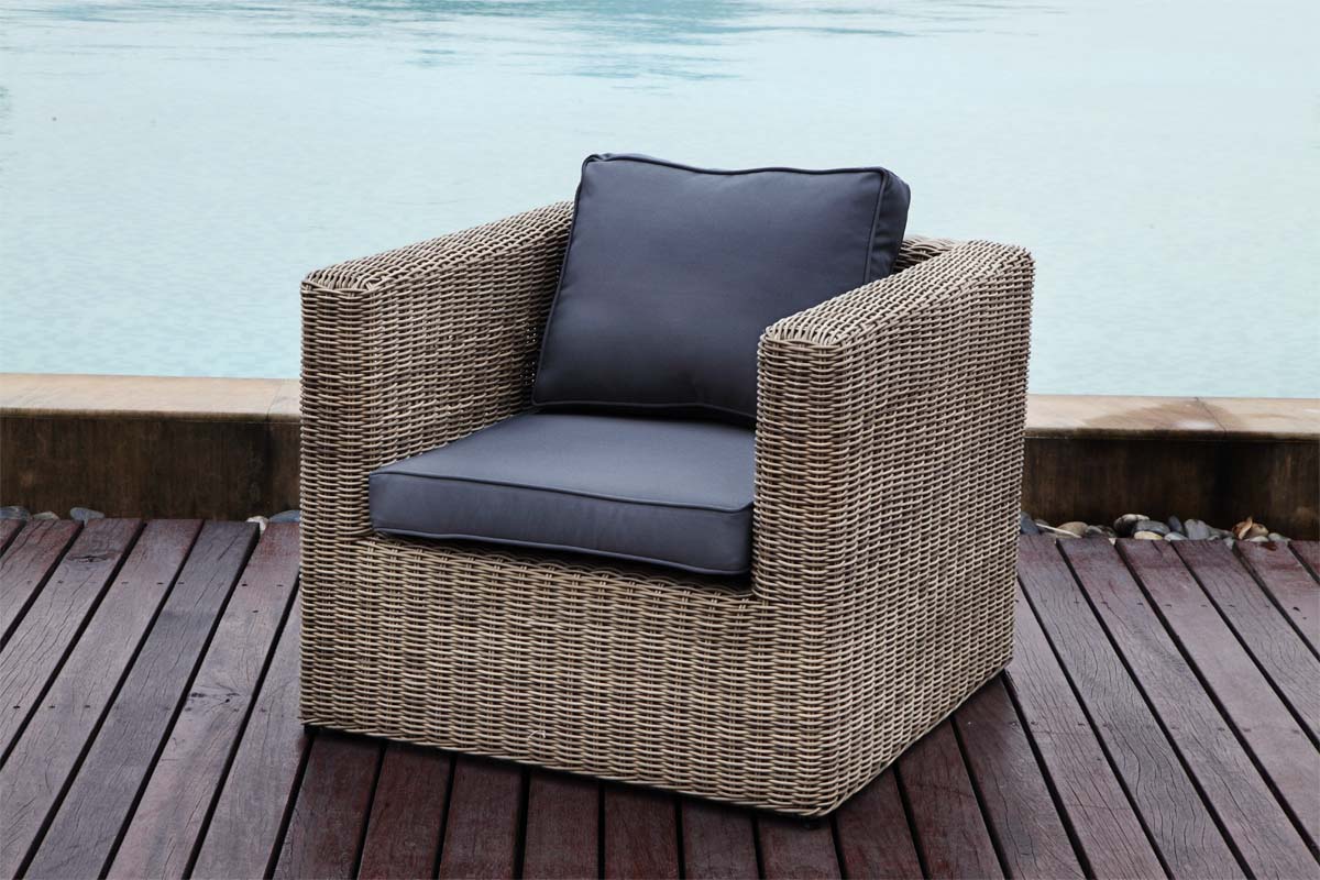 Armchair from the Liberty Chic 7-seat modular resin wicker sectional with poufs – shown outdoors
