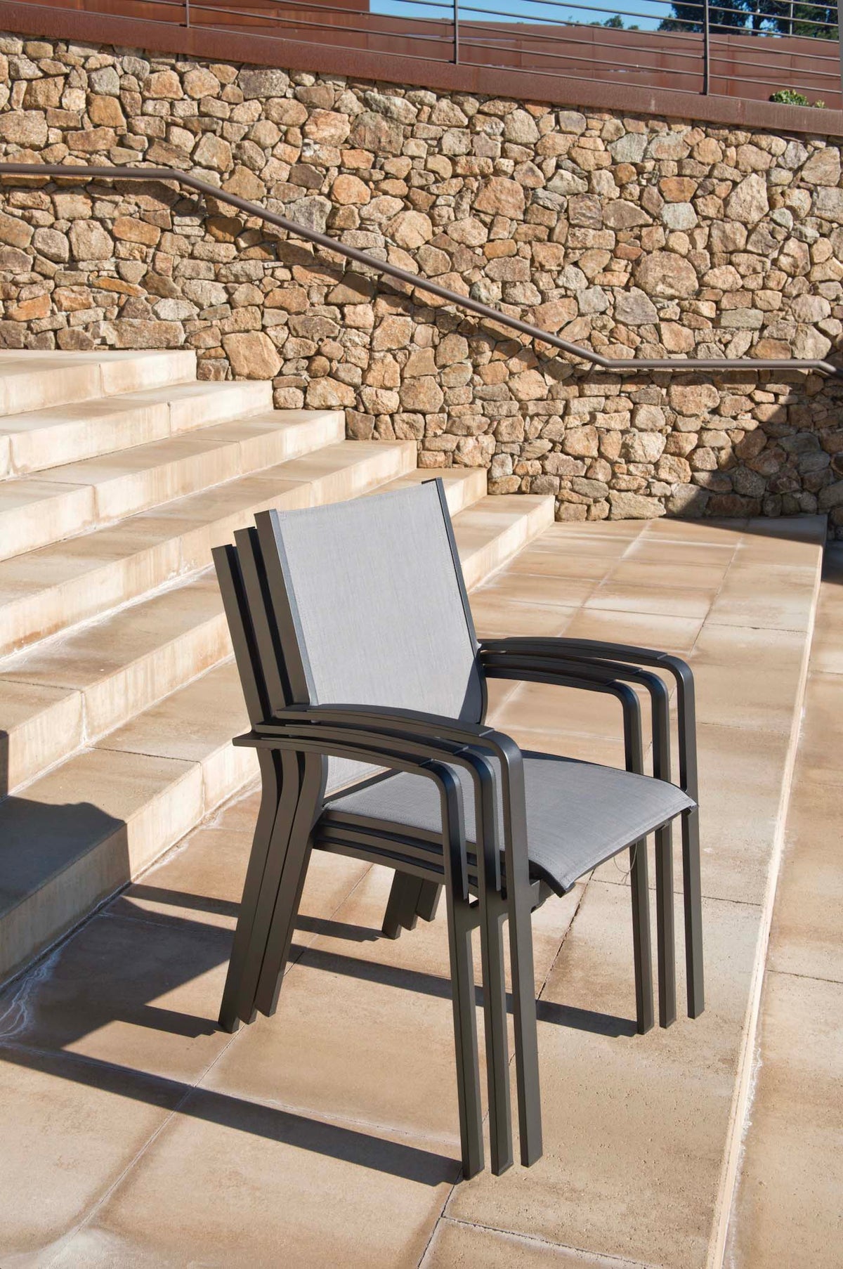 Nory Plus black stackable aluminum dining armchairs, set of 6 – shown outdoors (3)