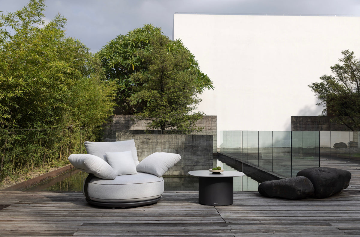 Armchair from the Elyo 5-seat gray curved aluminum outdoor sofa set – shown outdoors