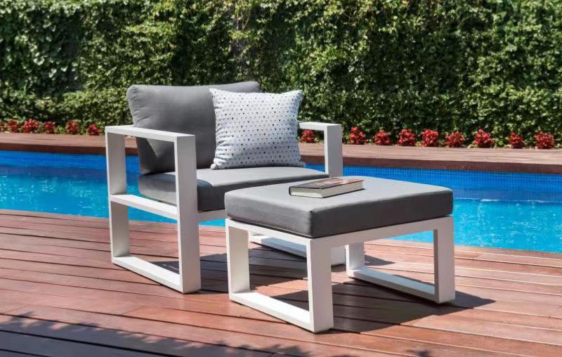 Belly white aluminum outdoor armchair with matching ottoman – shown outdoors (3)