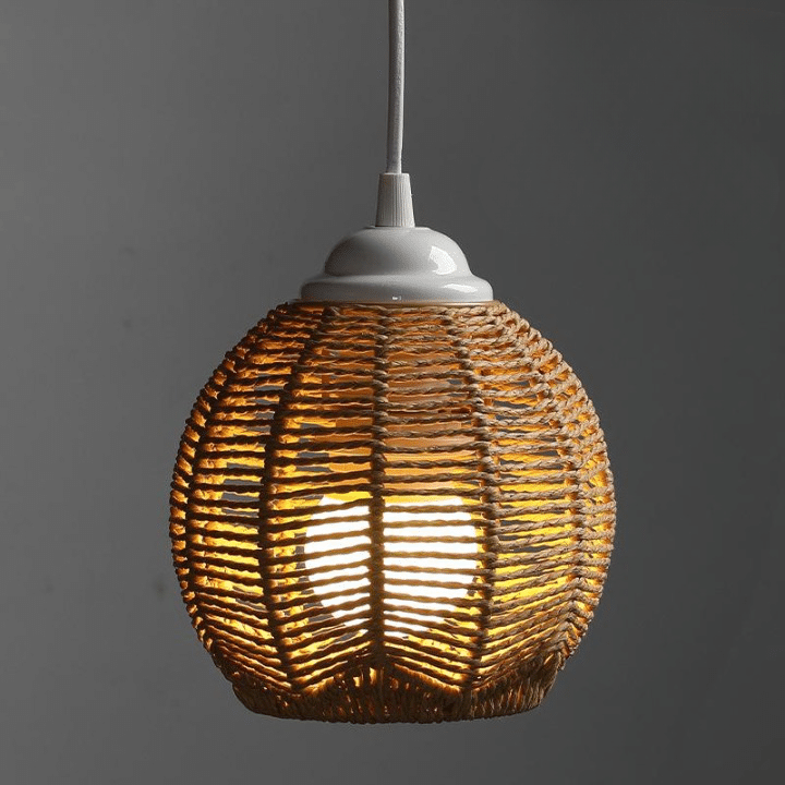 Rustic woven rattan lamp shade with golden reflections – shown lit