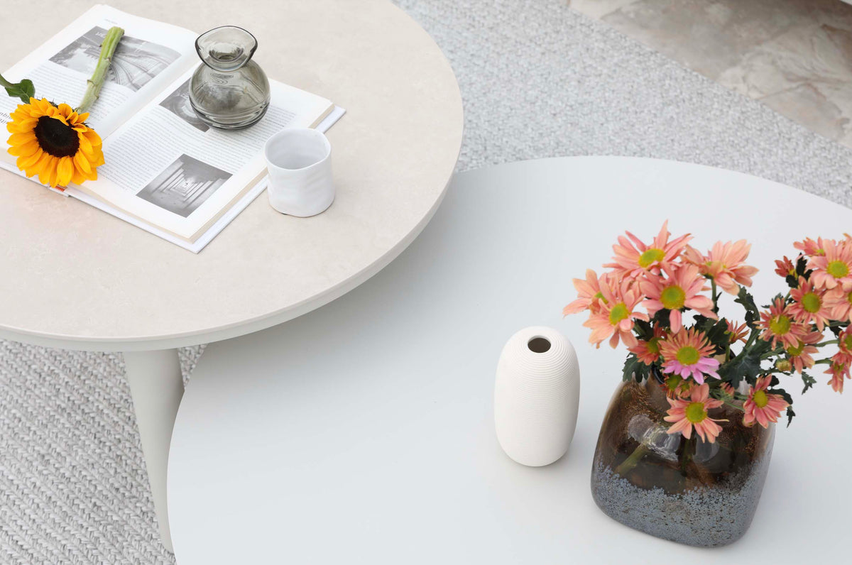 Coffee table from the Flora 4-seat white aluminum loveseat set with beige cushions – close-up detail