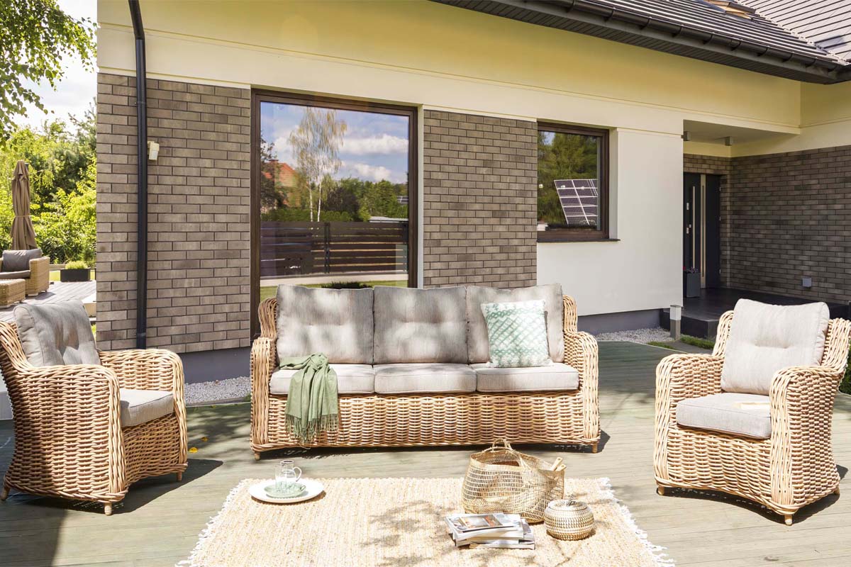 Mila resin wicker sofa set with 3-seat sofa and two armchairs in wicker color – shown outdoors