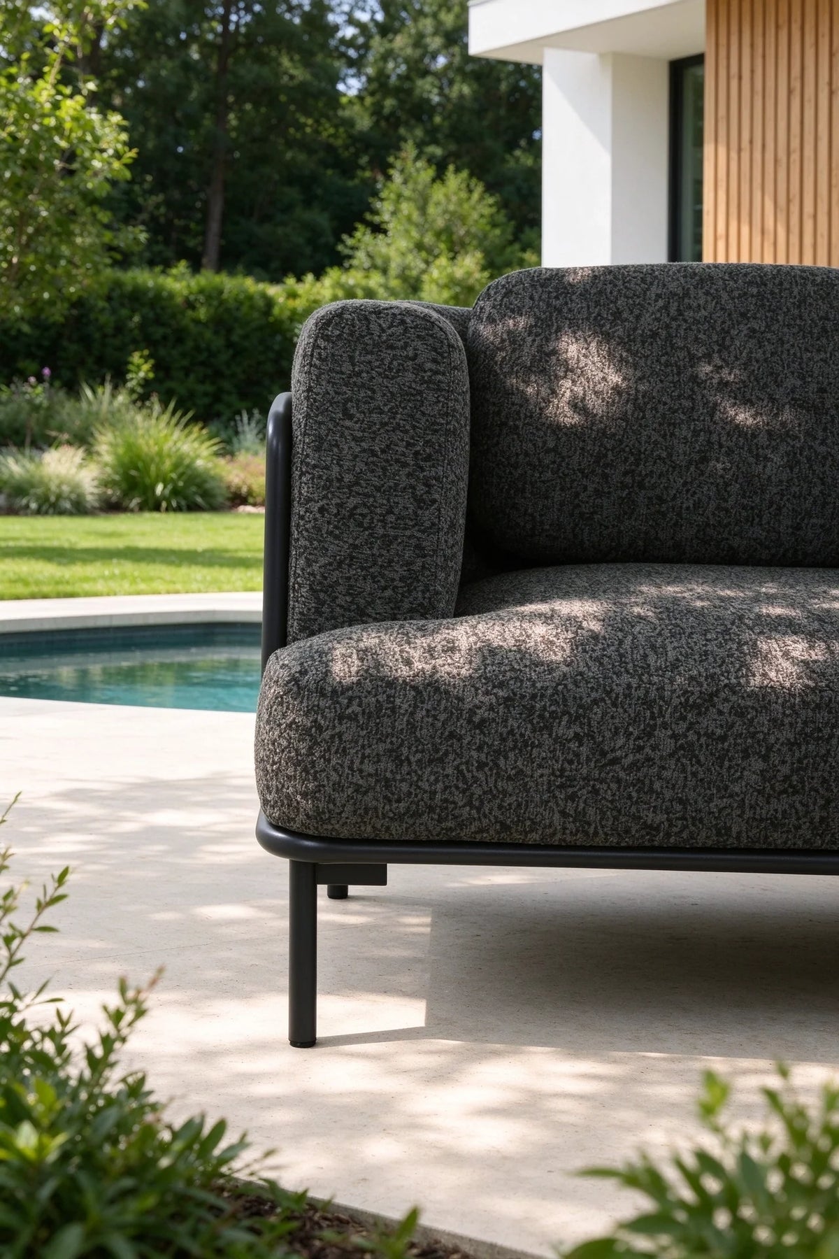 Flora anthracite aluminum loveseat set upholstered in black boucle – shown outdoors (4)