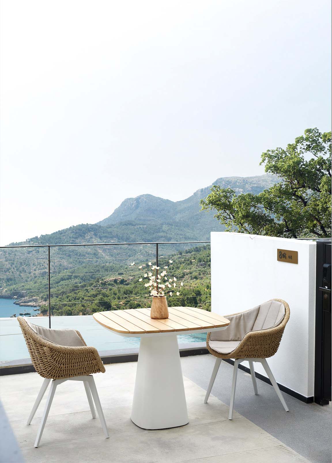 Milo square solid teak top patio table – shown outdoors (3)