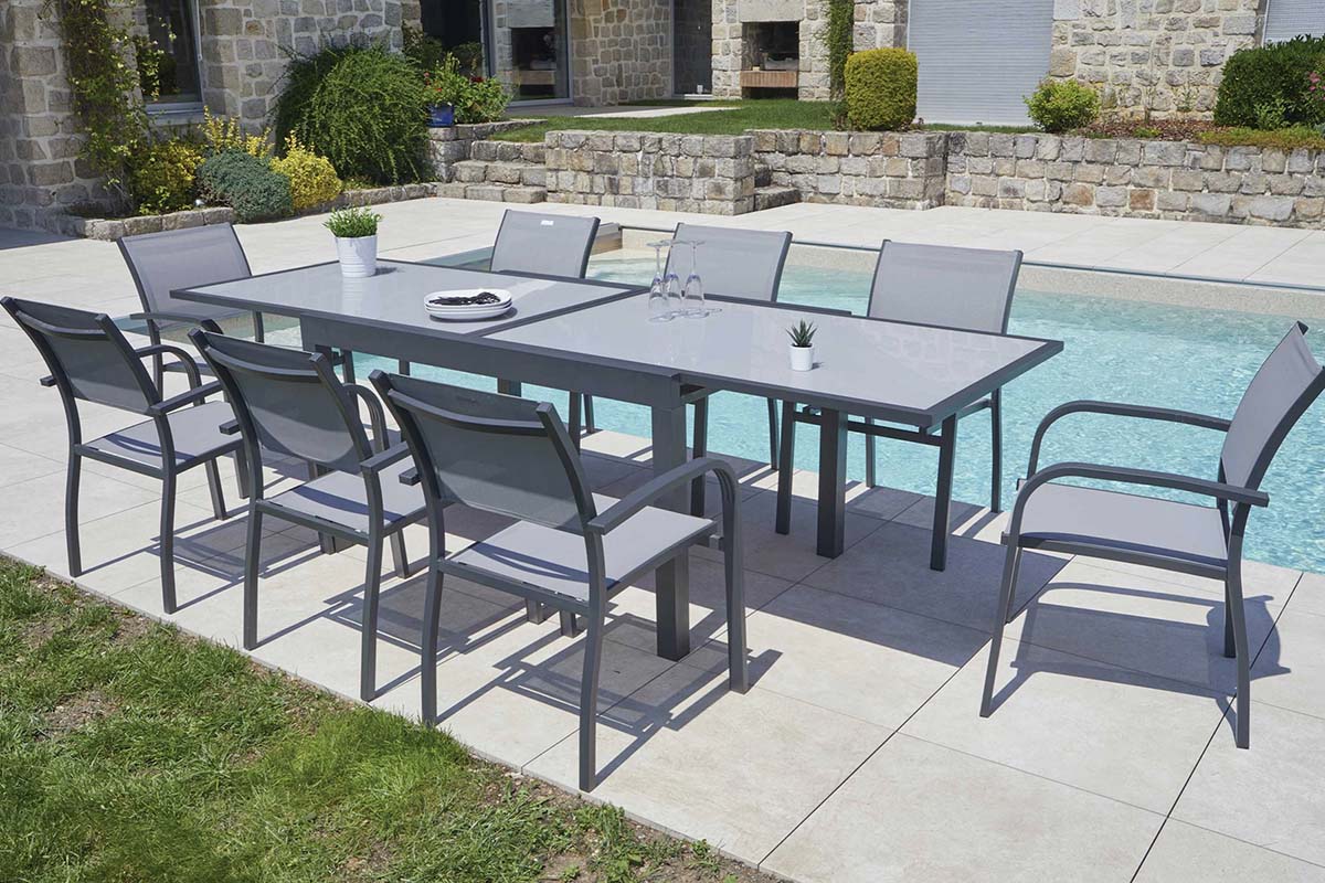Fancy extendable aluminum table with smoked gray glass top – shown outdoors (3)
