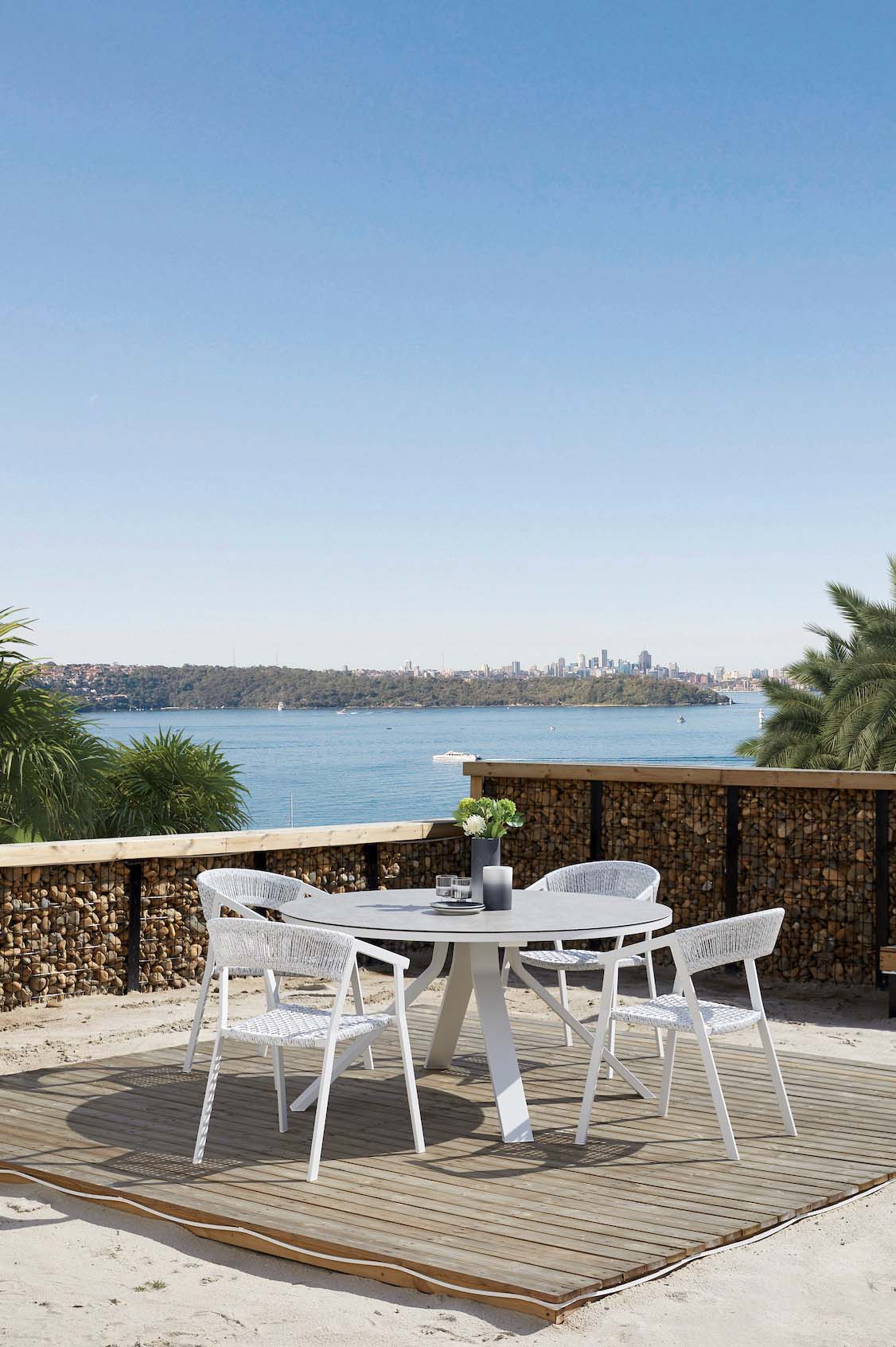 Mondo round white aluminum table with marble-effect glass top – shown outdoors (4)