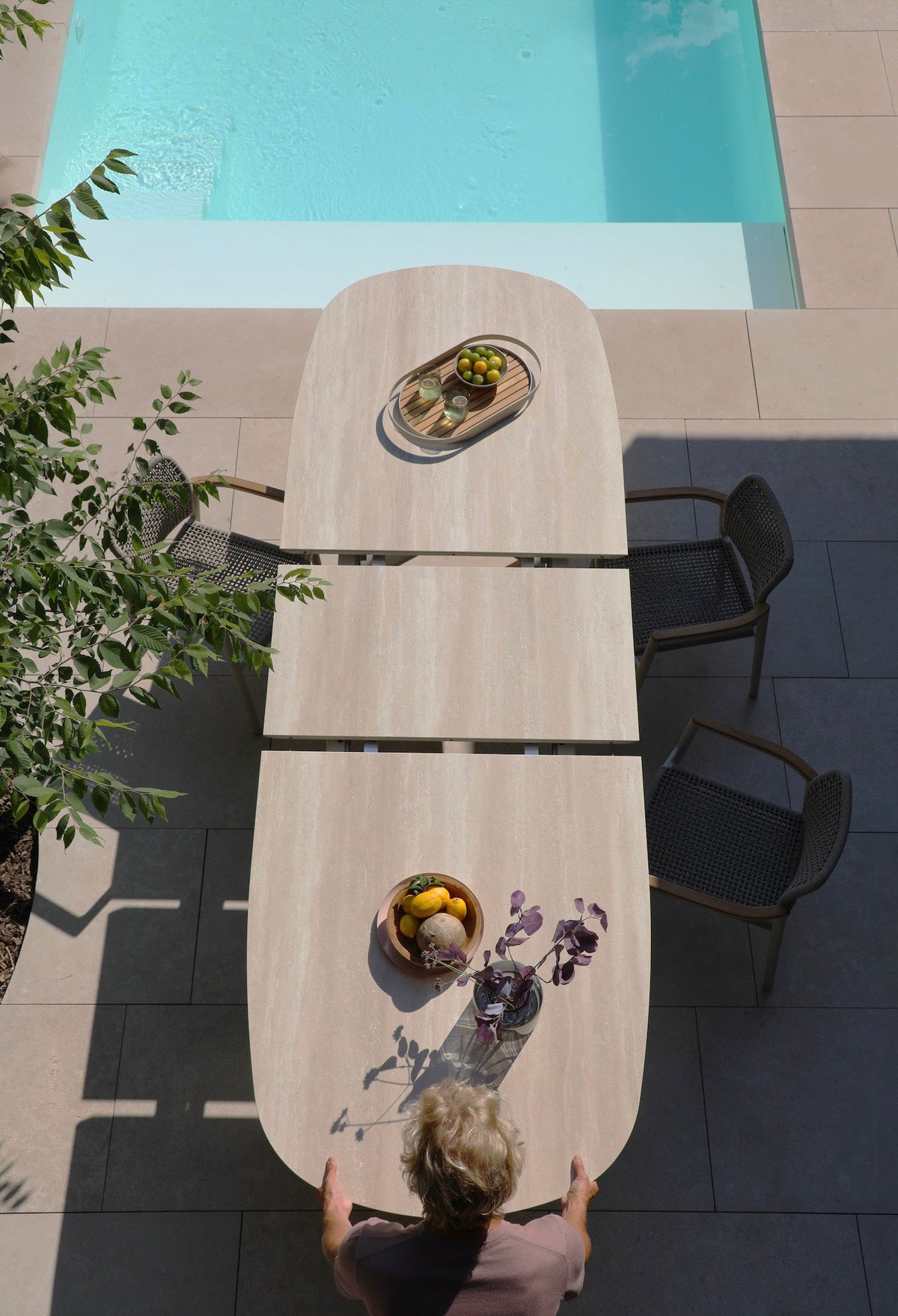 Livio beige oval extendable ceramic outdoor dining table – shown outdoors (4)