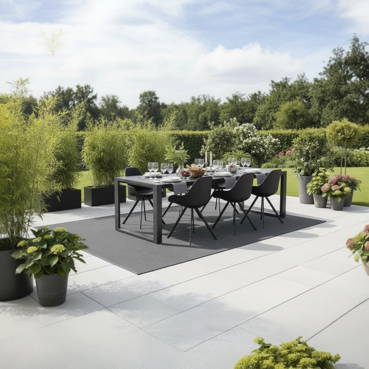 Como black aluminum ceramic-top outdoor dining table – shown outdoors