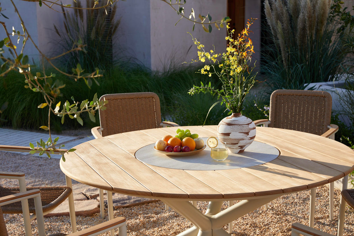 Ariel round teak outdoor dining table with rotating ceramic center – shown outdoors (5)