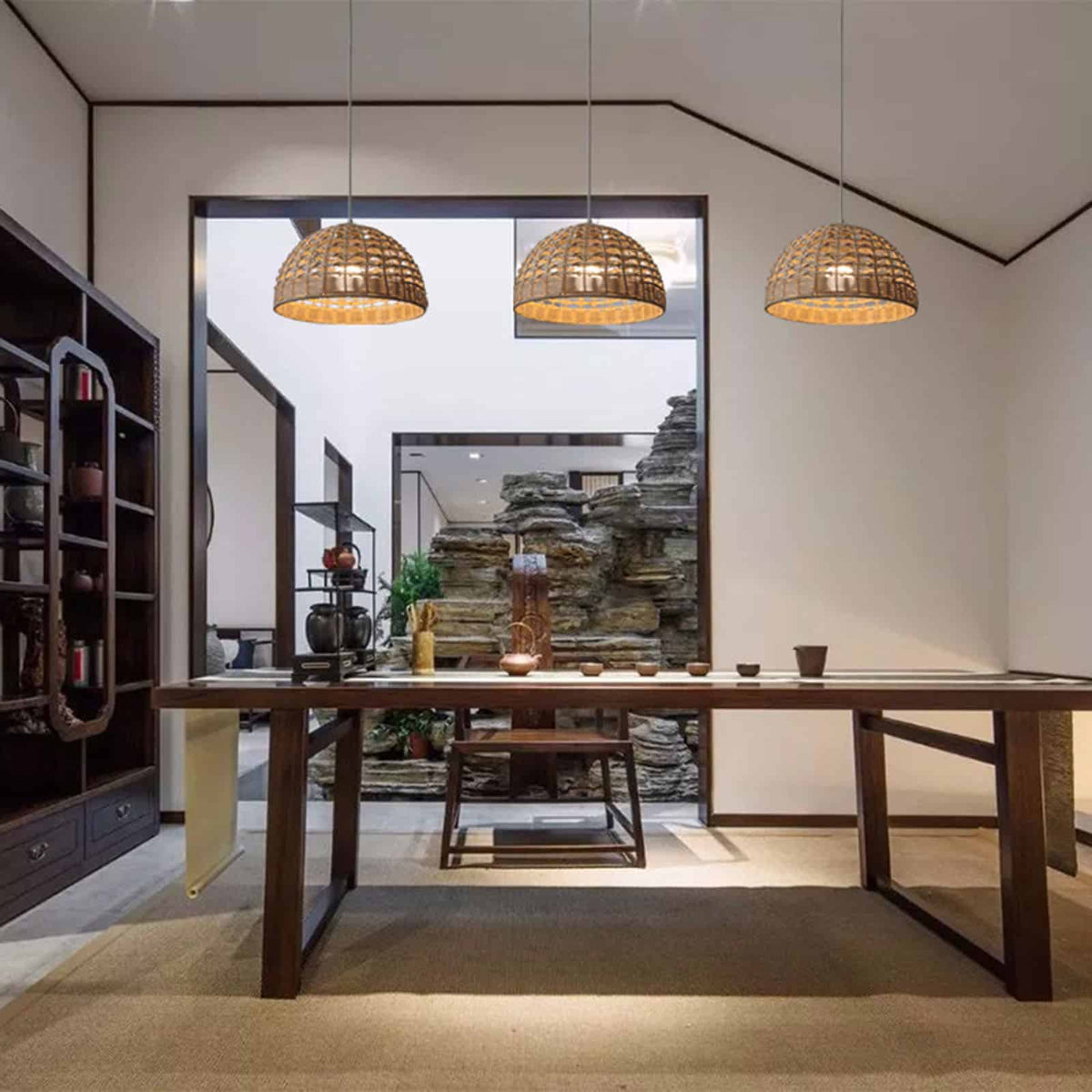 Ovoid handwoven rattan and wicker pendant shade – shown in a room setting