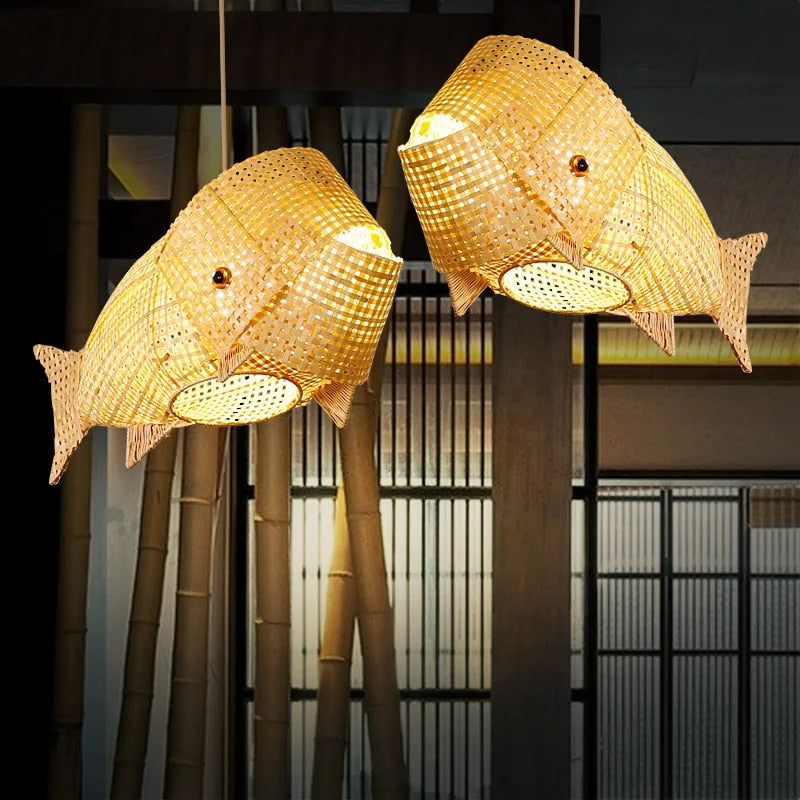 Handwoven rattan koi carp shaped ceiling light – shown lit in a room setting (2)