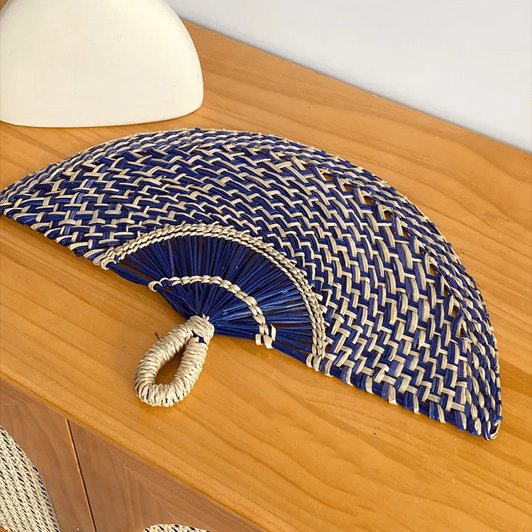 Blue woven rattan fan wall decor with radiating ribs – shown in a room setting