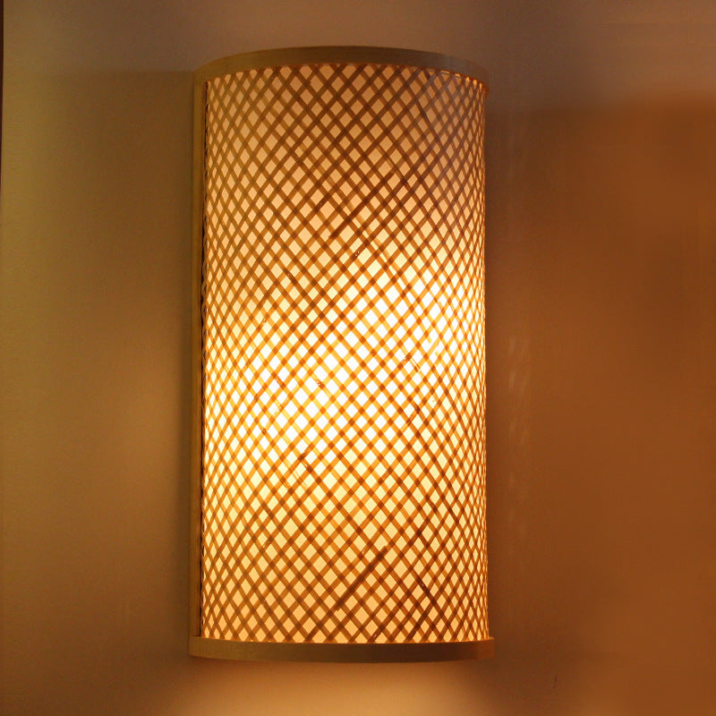 Framed rectangular handwoven rattan wall light – shown lit