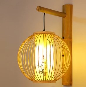 Round rattan wall sconce with an Asian-inspired woven pattern – shown lit
