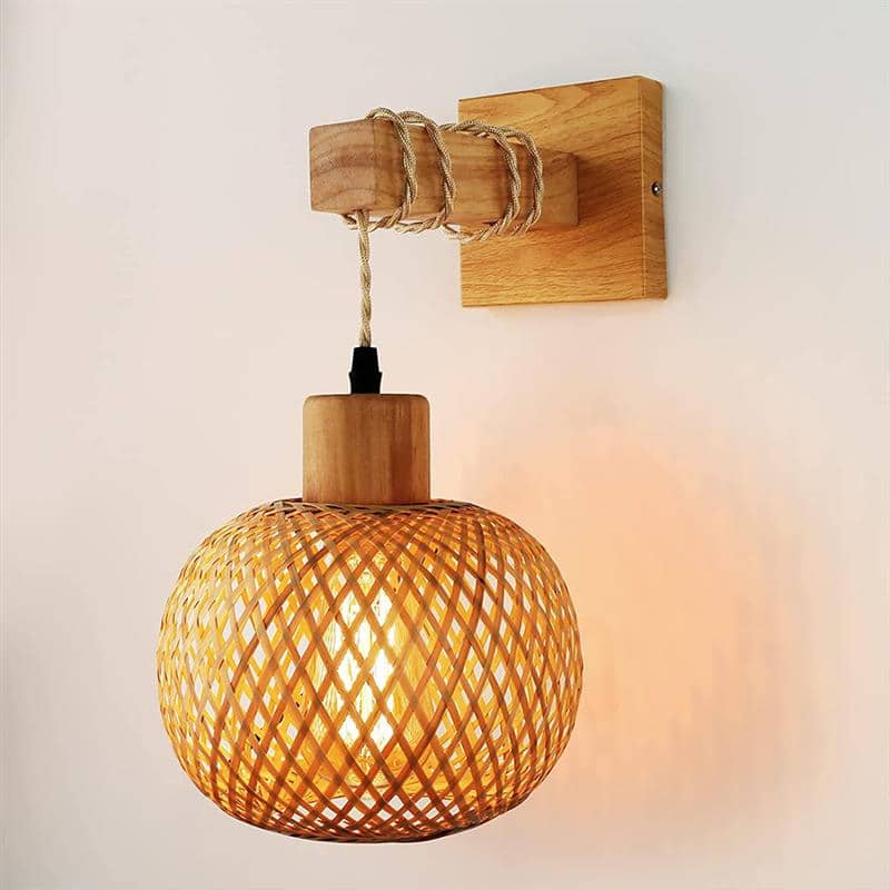 Retro wall sconce with a wood frame and handwoven rattan shade – shown lit