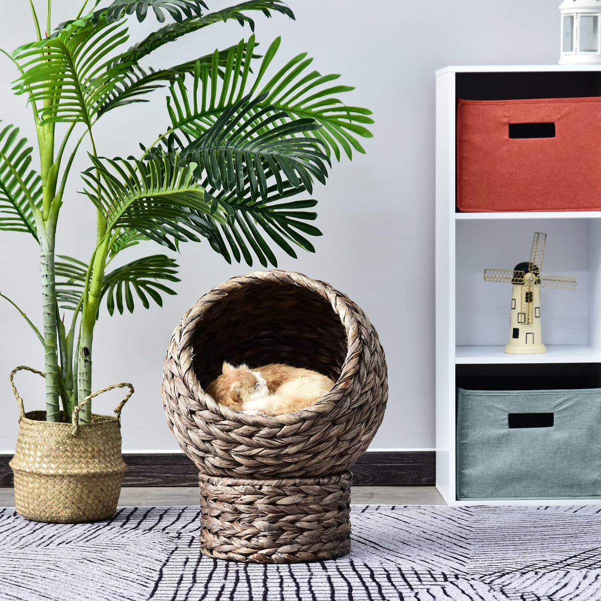 Natural rattan cat tree with a cushioned round basket – shown in a room setting