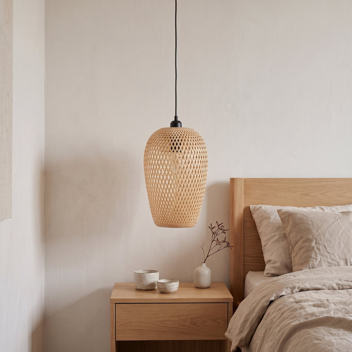 Oval woven bamboo bedside pendant light – shown in a room setting (2)