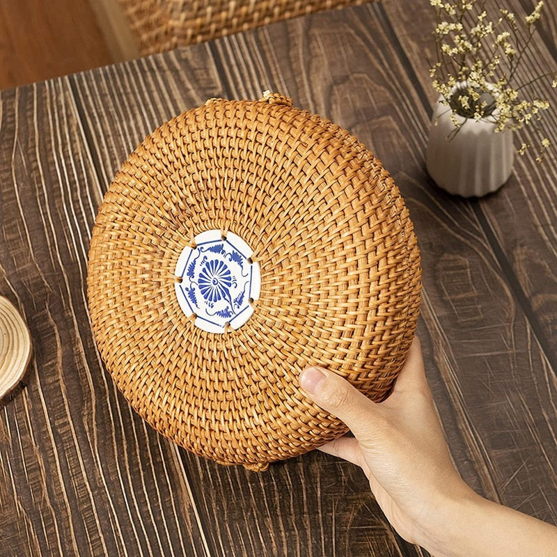 Round woven rattan jewelry box with a geometric pattern and lid – shown in use