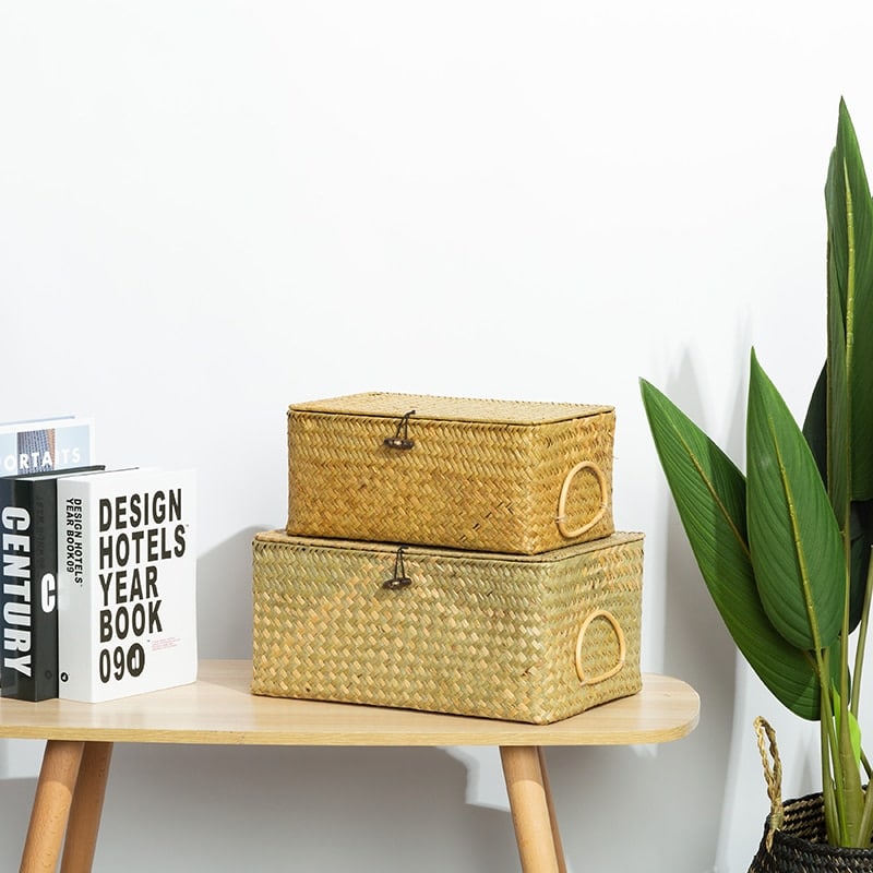 Rectangular rattan storage box with an attached handle – shown in a room setting