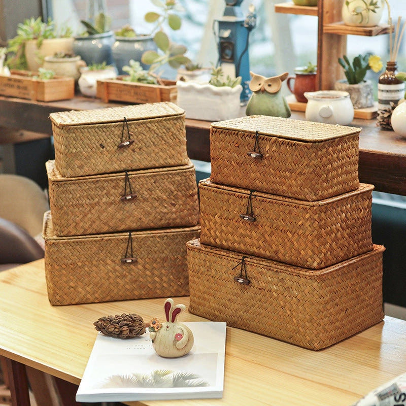 Hand-braided rattan storage basket with a lid, hook and side handles – shown in a room setting (2)