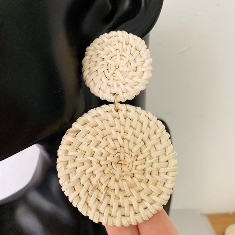 Round hand-braided rattan earrings – shown in use
