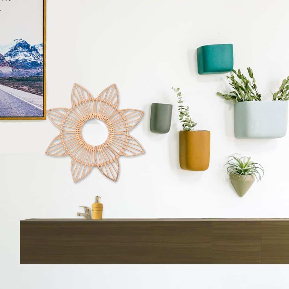 Sun motif rattan frame with hand-braided radiating stems – shown in a room setting