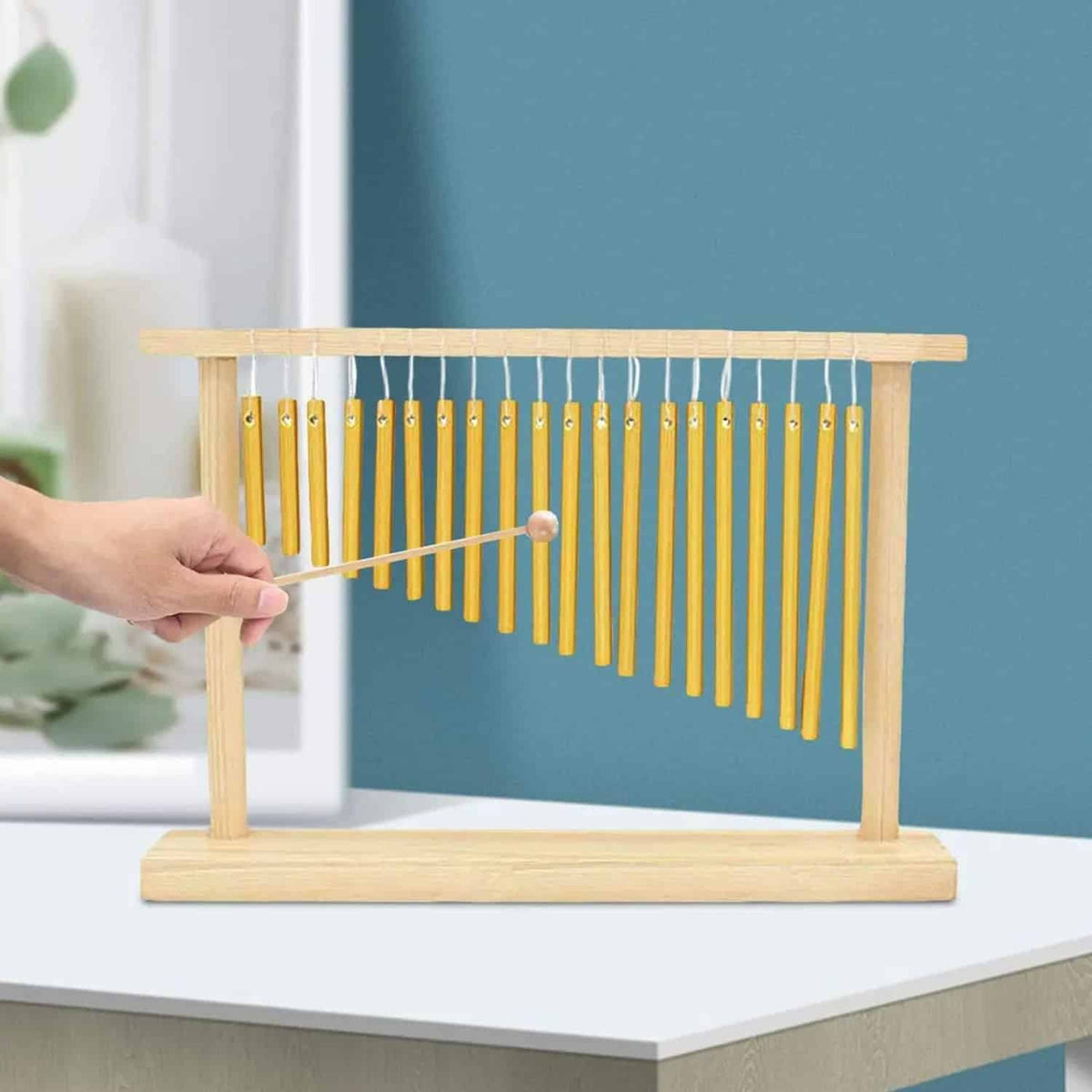 Sturdy bamboo wind chime with golden tubes – shown in use